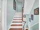 Beautiful staircase with wood treads, painted risers, and a classic handrail at 29 Smith St, Charleston, SC 29401