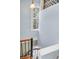 Elegant staircase with light blue walls and decorative window at 29 Smith St, Charleston, SC 29401