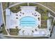 Aerial view of a community pool featuring lounge areas, palm trees, and well-maintained landscaping at 312 Greenhouse, Summerville, SC 29485
