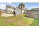 Spacious backyard featuring a detached garage, basketball hoop, and lush green grass at 312 Greenhouse, Summerville, SC 29485