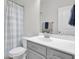 Neutral bathroom featuring white vanity with gray cabinets, toilet, tub, and shower with tiled accents at 312 Greenhouse, Summerville, SC 29485