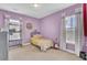 Cozy, decorated bedroom featuring a bed, desk, carpet, and a large window that brings in natural light at 312 Greenhouse, Summerville, SC 29485