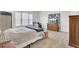 Bedroom featuring wood floors, large windows, a bed, a computer desk and a decorative wood dresser at 312 Greenhouse, Summerville, SC 29485