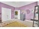 Bright bedroom with lavender walls, carpet and decorated with a wall mirror and a wooden dresser at 312 Greenhouse, Summerville, SC 29485
