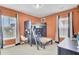 A bedroom with orange walls featuring a bunkbed with a desk and chair underneath at 312 Greenhouse, Summerville, SC 29485