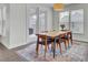 Cozy dining area with natural light, wooden table and chairs, and a decorative area rug at 312 Greenhouse, Summerville, SC 29485
