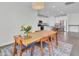 Bright dining room with hardwood floors, stylish rug, and table adjacent to open kitchen at 312 Greenhouse, Summerville, SC 29485