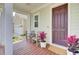 Cozy porch with chairs and a potted plant, inviting guests to relax near the front door at 312 Greenhouse, Summerville, SC 29485