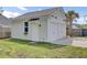 Detached garage with dual doors, a side entry door, and manicured lawn and landscape at 312 Greenhouse, Summerville, SC 29485