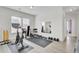 Bright home gym featuring fitness equipment, a mirror, and natural light for an energizing workout space at 312 Greenhouse, Summerville, SC 29485