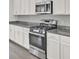 Modern kitchen featuring stainless steel appliances, granite countertops, and white cabinetry at 312 Greenhouse, Summerville, SC 29485