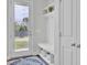 Entryway mud room with white bench seating and storage leading to an outdoor backyard view at 312 Greenhouse, Summerville, SC 29485