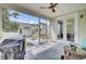 A sunroom with a ceiling fan, screened windows and sliding glass doors, and wicker furniture at 312 Greenhouse, Summerville, SC 29485