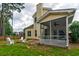 Backyard with screened porch, patio, and white Adirondack chairs surrounding a fire pit at 314 Freeland Way, Moncks Corner, SC 29461