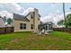 Exterior view of a yellow home with a lush lawn and cozy screened porch at 314 Freeland Way, Moncks Corner, SC 29461