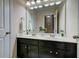 Bright bathroom featuring a double sink vanity with black cabinets and a large mirror at 314 Freeland Way, Moncks Corner, SC 29461