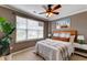 A bedroom with a window, a bed, white nightstands, and a ceiling fan for added comfort and lighting at 314 Freeland Way, Moncks Corner, SC 29461