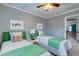 Charming bedroom with two twin beds, decorative pillows and overhead fan at 314 Freeland Way, Moncks Corner, SC 29461