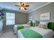 Charming bedroom with two twin beds, decorative pillows and overhead fan at 314 Freeland Way, Moncks Corner, SC 29461