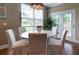 Cozy dining area with a white table, seating for six, and a modern pendant light fixture at 314 Freeland Way, Moncks Corner, SC 29461