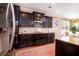 This is a kitchen with dark cabinets, granite countertops, stainless steel appliances, and a tile backsplash at 314 Freeland Way, Moncks Corner, SC 29461