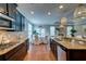 A kitchen featuring dark cabinets and granite countertops that opens up to a dining room and living room at 314 Freeland Way, Moncks Corner, SC 29461