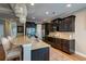 A kitchen featuring dark cabinets, granite countertops, stainless steel appliances, with adjacent barstool seating at 314 Freeland Way, Moncks Corner, SC 29461