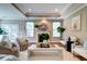Bright living room showcasing a fireplace, large windows, and elegant decor at 314 Freeland Way, Moncks Corner, SC 29461