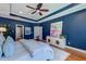 Beautiful bedroom featuring tray ceiling, wooden floors, and bright window at 314 Freeland Way, Moncks Corner, SC 29461