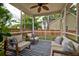 Covered porch with comfortable seating and view of the fenced backyard at 314 Freeland Way, Moncks Corner, SC 29461