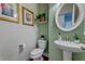 Charming powder room featuring green walls and a pedestal sink at 314 Freeland Way, Moncks Corner, SC 29461
