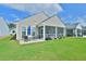 Backyard with a patio for outdoor dining and a screened porch, perfect for entertaining at 344 Seaside Trl, Summerville, SC 29486