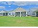 View of a nice backyard with a patio for grilling and a screened in porch at 344 Seaside Trl, Summerville, SC 29486