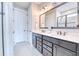 Bathroom features double sinks with vanity, a decorative mirror, and tiled flooring at 344 Seaside Trl, Summerville, SC 29486