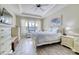 Serene bedroom with tray ceiling, large window, and white wooden furniture at 344 Seaside Trl, Summerville, SC 29486