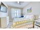 Comfortable bedroom with natural light, a ceiling fan, and a TV for relaxation at 344 Seaside Trl, Summerville, SC 29486