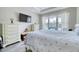 Bright bedroom features a mounted TV, a window, and wood look flooring at 344 Seaside Trl, Summerville, SC 29486