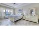 Serene bedroom with tray ceilings, a bed with floral bedding and a large window with natural light at 344 Seaside Trl, Summerville, SC 29486