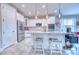 Kitchen with white cabinets, stainless appliances, island seating, and wood-look flooring at 344 Seaside Trl, Summerville, SC 29486