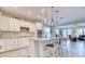 Kitchen with white cabinets, stainless appliances, island seating open to the living space at 344 Seaside Trl, Summerville, SC 29486
