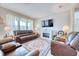 Cozy living room featuring a fireplace, plush leather seating, and lots of natural light at 344 Seaside Trl, Summerville, SC 29486