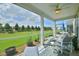 Screened porch with comfortable seating and view of manicured lawn with mature trees at 344 Seaside Trl, Summerville, SC 29486