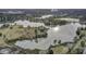 Expansive aerial view showcasing a serene lake bordered by lush greenery and mature trees at 351 Gnarly Oak Ln, Summerville, SC 29485