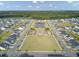 Community aerial view with a pond, manicured green spaces, playground, and neatly arranged residential housing at 351 Gnarly Oak Ln, Summerville, SC 29485