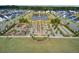 Aerial showcasing a neighborhood park with a pond, playground, walking paths, and lush landscaping between houses at 351 Gnarly Oak Ln, Summerville, SC 29485