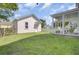 Exterior shot of the backyard showing garage, porch and green lawn at 351 Gnarly Oak Ln, Summerville, SC 29485