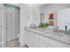 Bathroom with double vanity, white marble countertop, framed mirror, and a tiled shower with a shower curtain at 351 Gnarly Oak Ln, Summerville, SC 29485