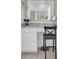 Bathroom vanity with a mirror, marble countertop, white cabinets, and a chair. A scale sits on the floor at 351 Gnarly Oak Ln, Summerville, SC 29485