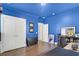 Bright blue bedroom with hardwood floors and multiple white closets at 351 Gnarly Oak Ln, Summerville, SC 29485