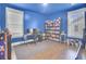 Bright blue bedroom with hardwood floors and multiple windows for natural light at 351 Gnarly Oak Ln, Summerville, SC 29485